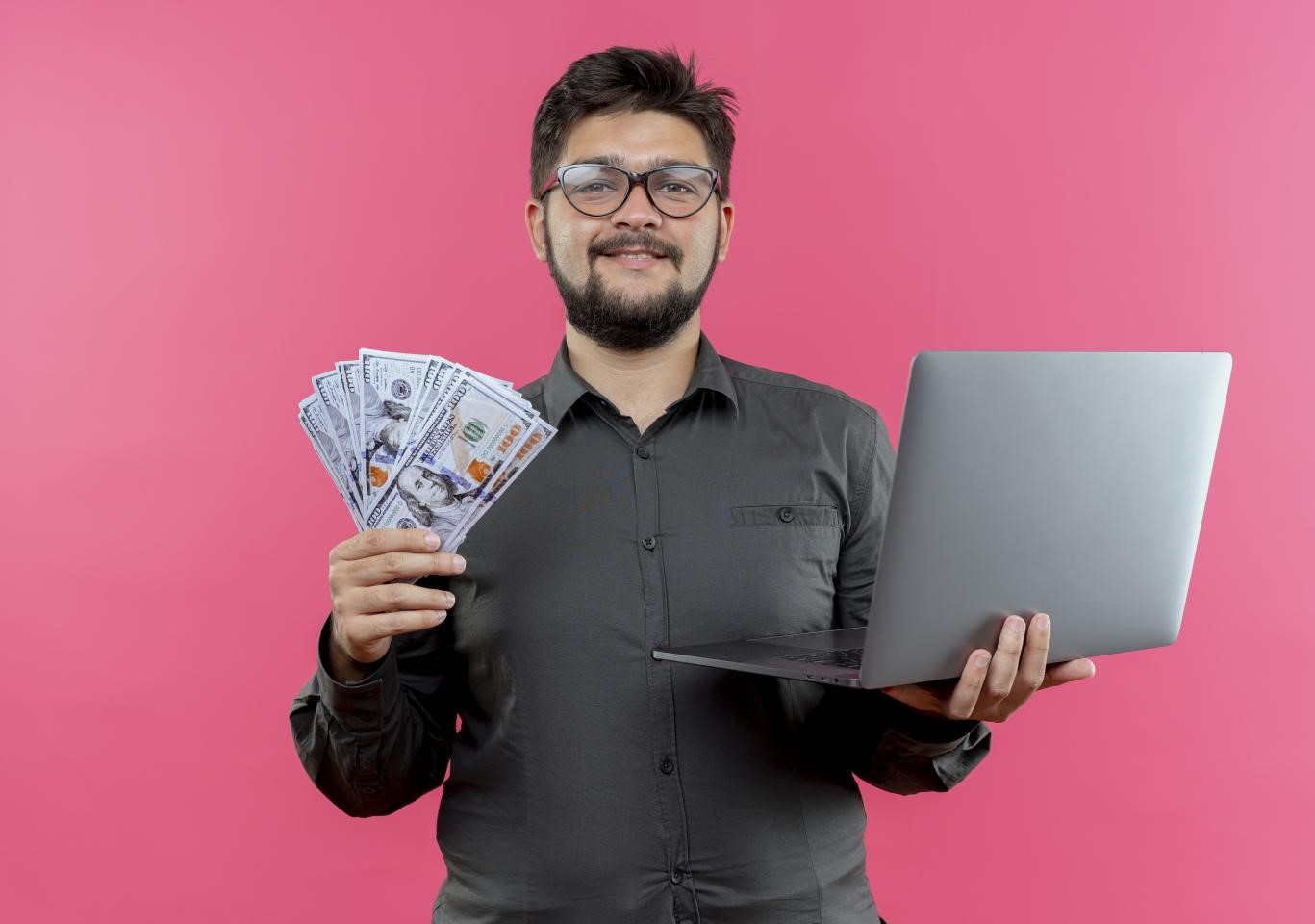 VLSI engineer in India holding money and a laptop.